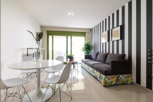 a living room filled with furniture and a table at Athens Mosaico Suites & Apartments in Athens