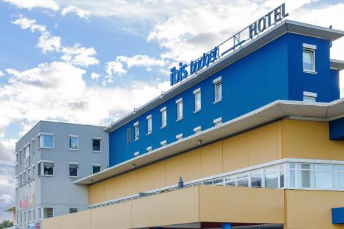 a blue building with the words main hotel on top at Ibis Budget Salzburg Airport - Self-Check-In in Salzburg