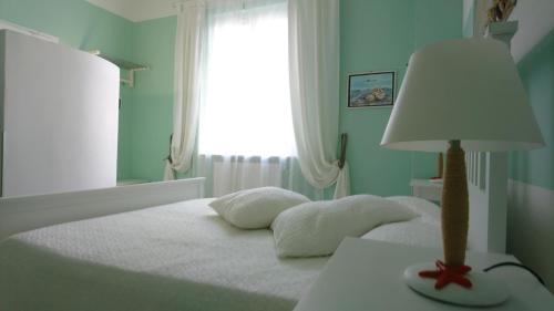 a bedroom with a bed with a lamp on a table at La Divina in Muggiano
