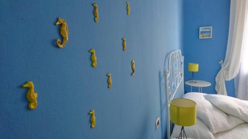 a bedroom with a blue wall with corn dogs on it at La Divina in Muggiano