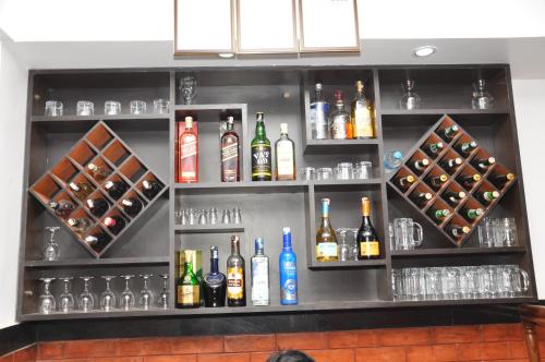 a bar with a bunch of bottles of alcohol at Mandala Hotel Kathmandu in Kathmandu
