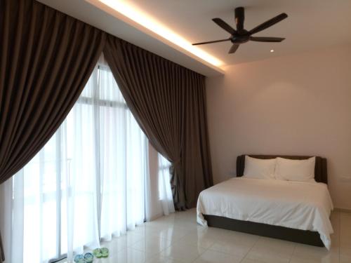 a bedroom with a bed and a ceiling fan at Imperial Cottage in Melaka