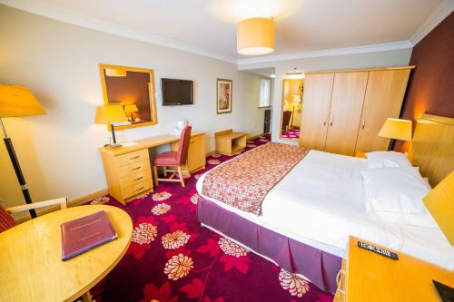 Katil atau katil-katil dalam bilik di Curran Court Hotel