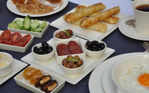 a table topped with plates of food with different foods at Ada Suites Nisantasi in Istanbul
