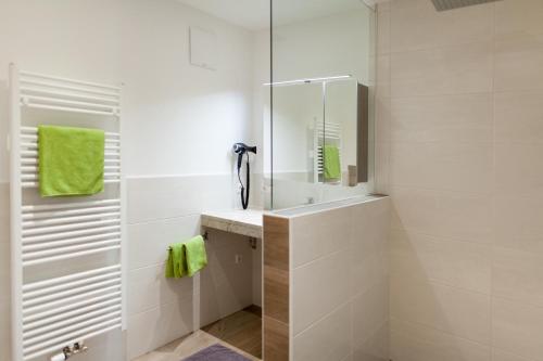 a white bathroom with a sink and a mirror at Standlhof in Mariapfarr