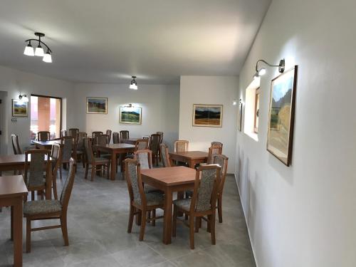 a dining room with wooden tables and chairs at Lex Studio in Praid