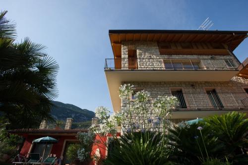 a building with a balcony on the side of it at Da Gianni e Villa Annamaria in Arco