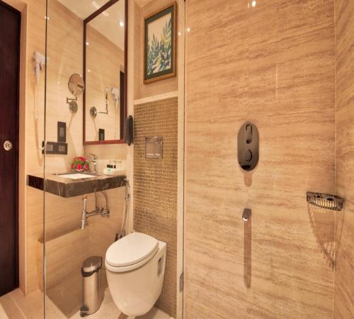 a bathroom with a toilet and a sink at Golden Tulip Essential Jaipur in Jaipur
