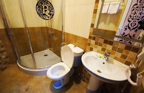 
a bathroom with a toilet, sink and tub at Black Sea Star Batumi in Batumi
