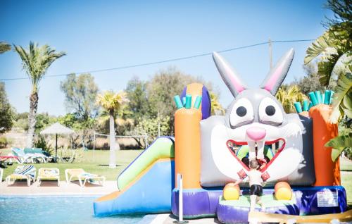 a inflatable bunny on a slide at a pool at Yellow Alvor Garden - All Inclusive in Alvor