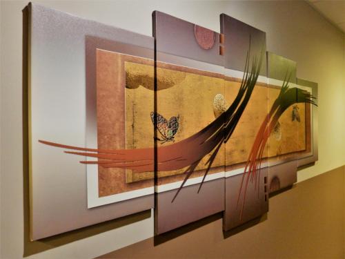 a painting hanging on a wall in a room at Hotel Saint Daniel in Péruwelz