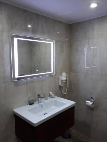 a bathroom with a sink and a mirror at Семеен хотел Анна-Кристина in Vidin