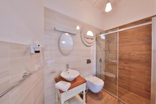 a bathroom with a sink and a toilet and a shower at Kose Konak Butik Hotel-Special in Alacati