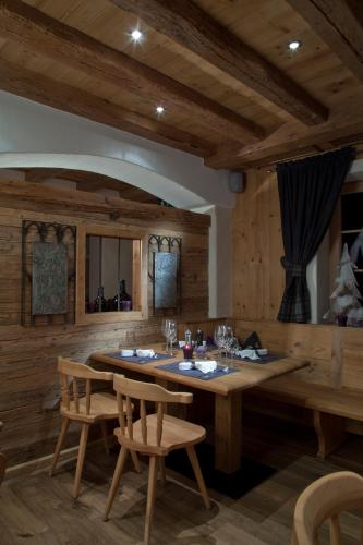 a dining room with a large wooden table and chairs at Landhotel Vordergrub in Kitzbühel