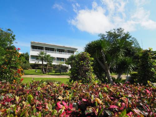a building with a lot of flowers in a park at Baan Ing Khao in Pak Chong