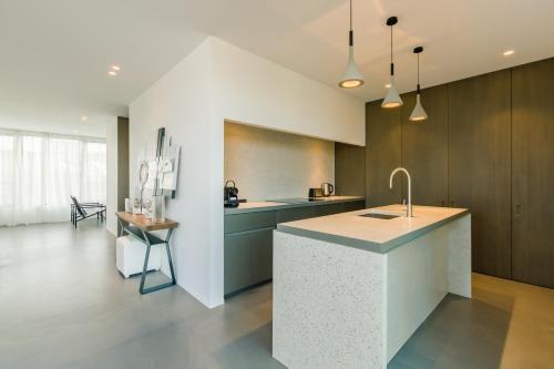a kitchen with a island in the middle of a room at The Livorno in Brussels