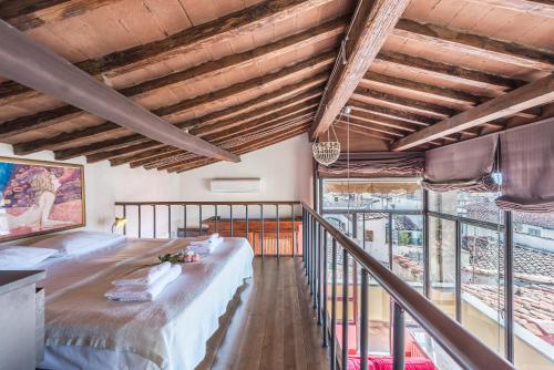a large room with a bed and a balcony at Loggia panoramica in Florence