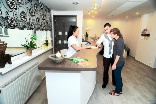 a group of people standing at a counter in a salon at Hotel Jantar Wellness & Spa in Ustka