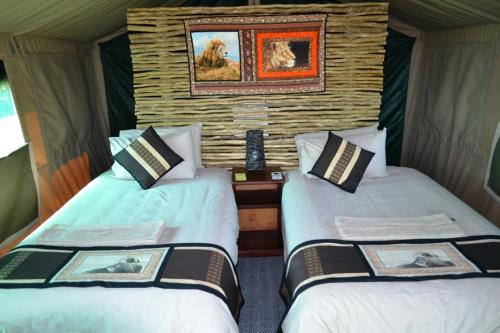 a room with two beds in a tent at Mwandi View in Kavimba