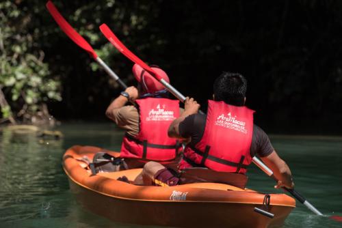 two people are in a kayak on the water at Las Guacamayas Lodge, Selva Lacandona, Chiapas México in Tlatizapán