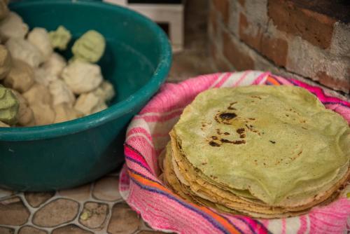a stack of pancakes next to a bowl of mushrooms at Las Guacamayas Lodge, Selva Lacandona, Chiapas México in Tlatizapán