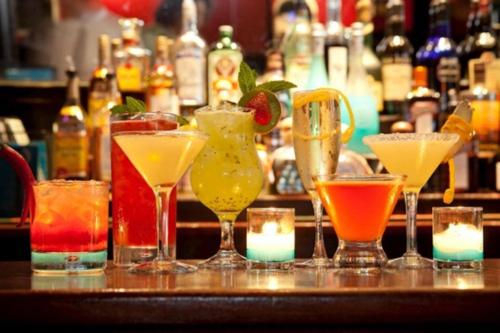 a group of different types of drinks on a bar at Aroma Angkor Boutique Hotel in Siem Reap