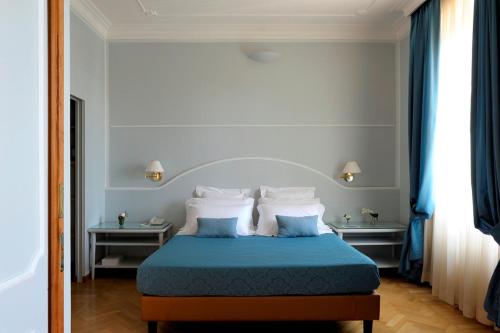 Postel nebo postele na pokoji v ubytování Dea Suite Roma
