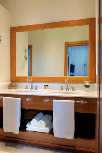 a bathroom with a sink and a large mirror at Dea Suite Roma in Rome