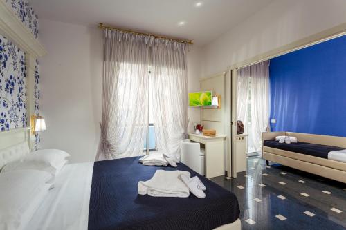 a bedroom with a bed with white towels on it at Hotel Feldberg in Riccione