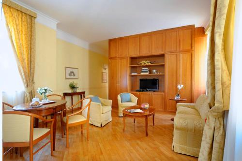 a living room with a table and a dining room at Dea Suite Roma in Rome