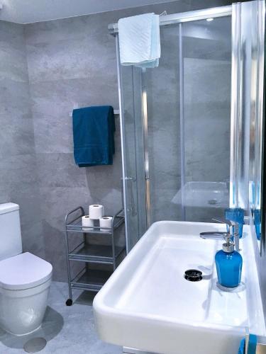 a bathroom with a white sink and a toilet at Club Playa Flores in Torremolinos