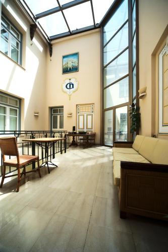 a large room with tables and a large glass ceiling at Capsis Bristol Boutique Hotel in Thessaloniki