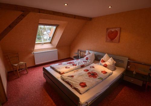 a bedroom with a bed with flowers on it at Ferienhaus Brockenbäcker in Tanne