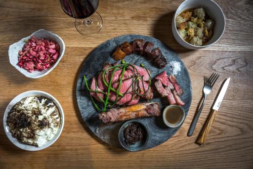 a plate of food with meat and vegetables on a table at MADE Hotel in New York