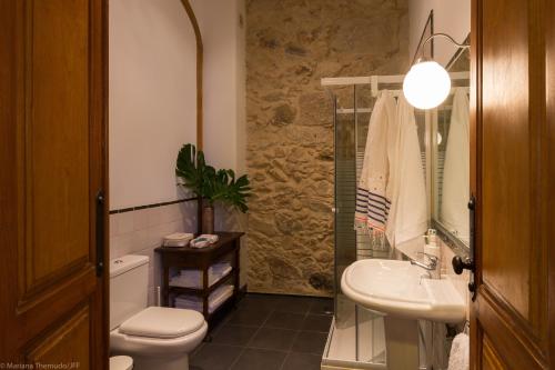 a bathroom with a toilet and a sink and a shower at Romantic - Casa Rua Bela in Porto