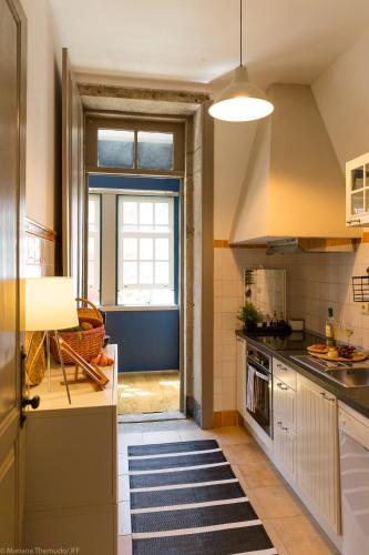 a kitchen with a sink and a stove at Romantic - Casa Rua Bela in Porto