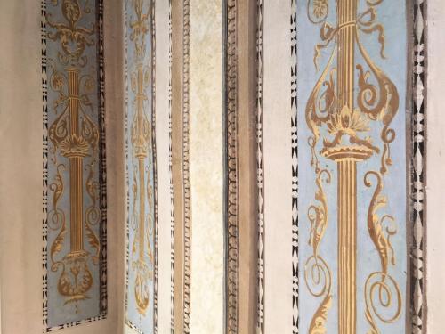 a row of books with gold and blue at Palazzo Suriano Heritage Hotel in Vietri sul Mare
