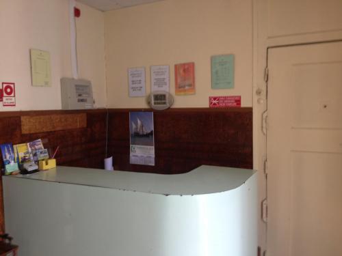 a room with a counter and a door with papers on the wall at Verde Esperança in Lisbon