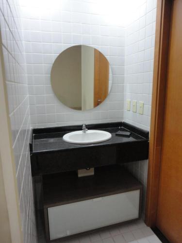 a bathroom with a sink and a mirror at Flat Privado Manaus in Manaus