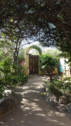an archway leading to a building with a door at Troncones Point Hostel in Troncones