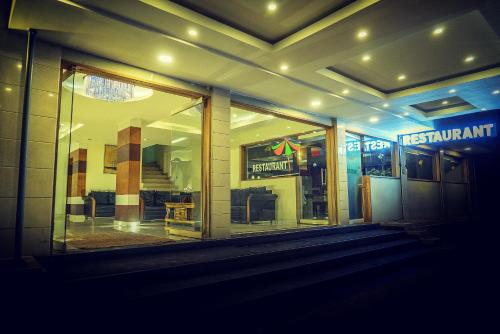 a store front with a window at night at Green Park Residency in Kannur