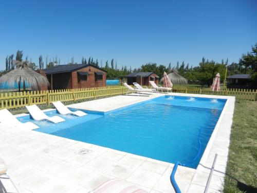 - une piscine avec des chaises longues dans la cour dans l'établissement Cabañas Haras de Cuyo, à San Rafael