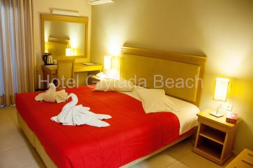 
A bed or beds in a room at Glyfada Beach Hotel
