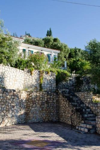 a stone wall with a building on top of it at Euktimeno in Vathi, Ithaka