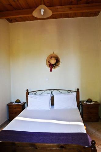 a bedroom with a white bed with two pillows at Euktimeno in Vathi, Ithaka