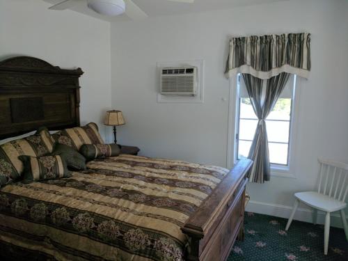 a bedroom with a large bed and a window at Inn at the Park in Cape May
