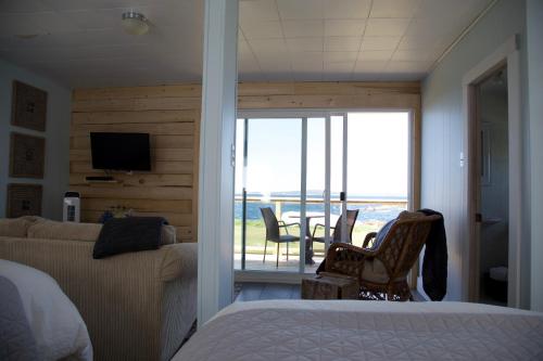 a bedroom with a bed and a view of the ocean at Crab Cottage in Peggy's Cove