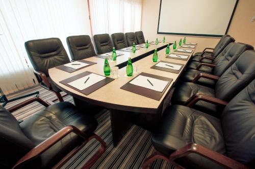 a conference room with a long table with green bottles at Premier Hotel Dnister in Lviv