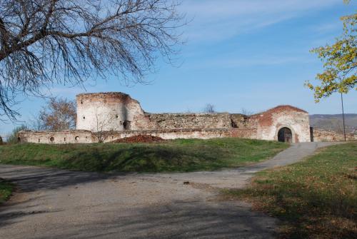 an old building on a hill with a dirt road at Atrijum Apartments and Rooms in Kladovo