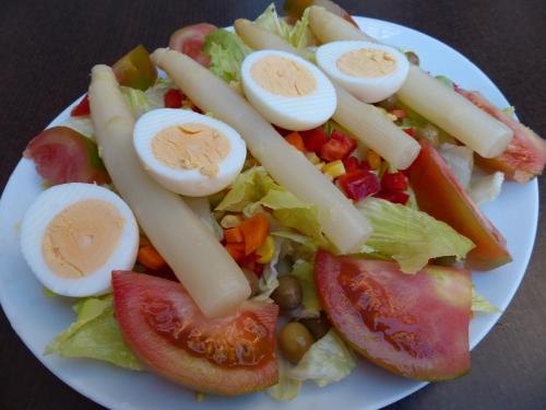 a plate of food with eggs and vegetables on it at Hostal Vall D'Aneu by Arcas & Sambola in Esterri d'Àneu